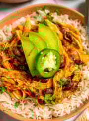 Bowls of shredded chicken and rice with beans.