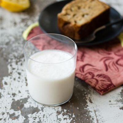 Glass of frosted coconut lemonade on rustic table